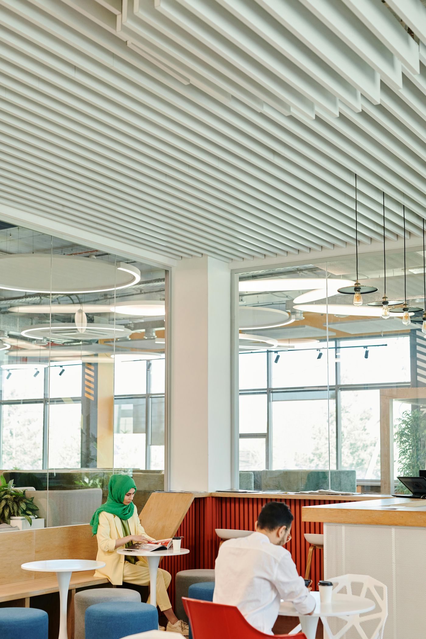 Suspended acoustic ceiling baffles and cloud systems in high-ceiling commercial space