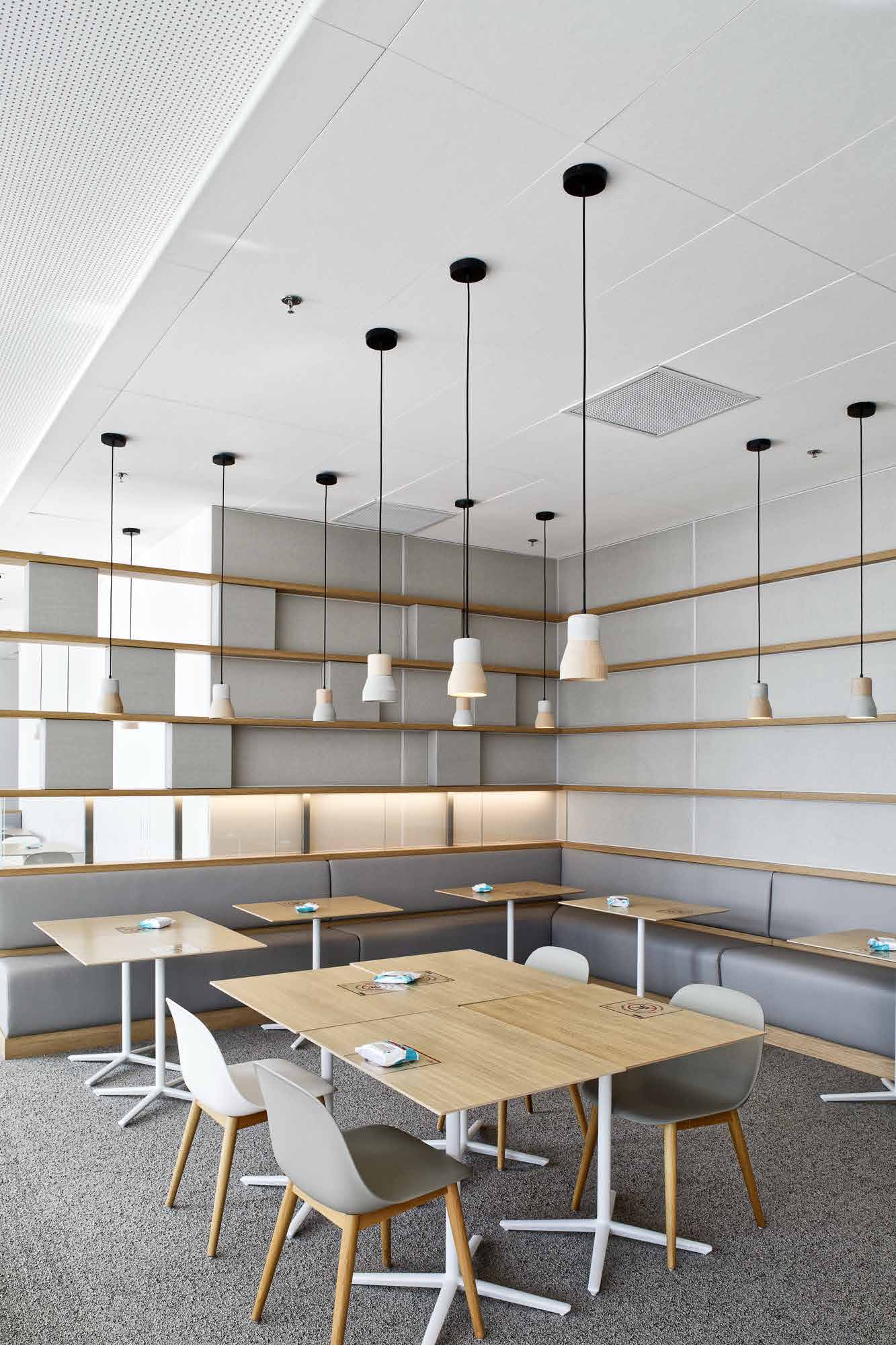 Acoustic mineral fiber ceiling tiles installed in modern open-plan office space